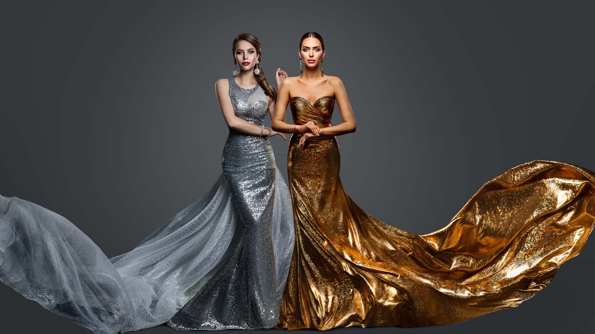 Fashionable two Woman in Golden Evening Dress and Silver Gown. Glamour Beauty Model Fashion Prom Clothes with Train. Studio