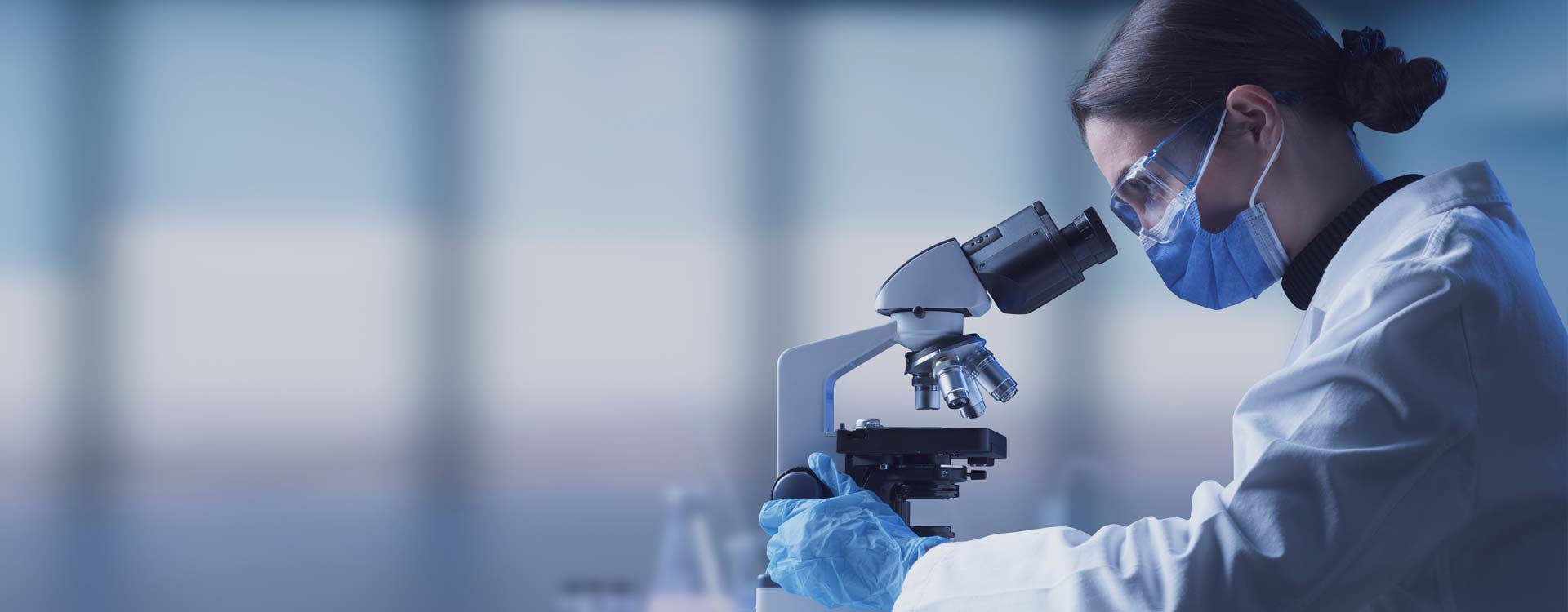 Researcher using a professional microscope